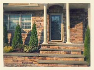 natural looking cultured stone boral chardonnay country ledgestone planter wall bluestone cap around garage steps and front of house